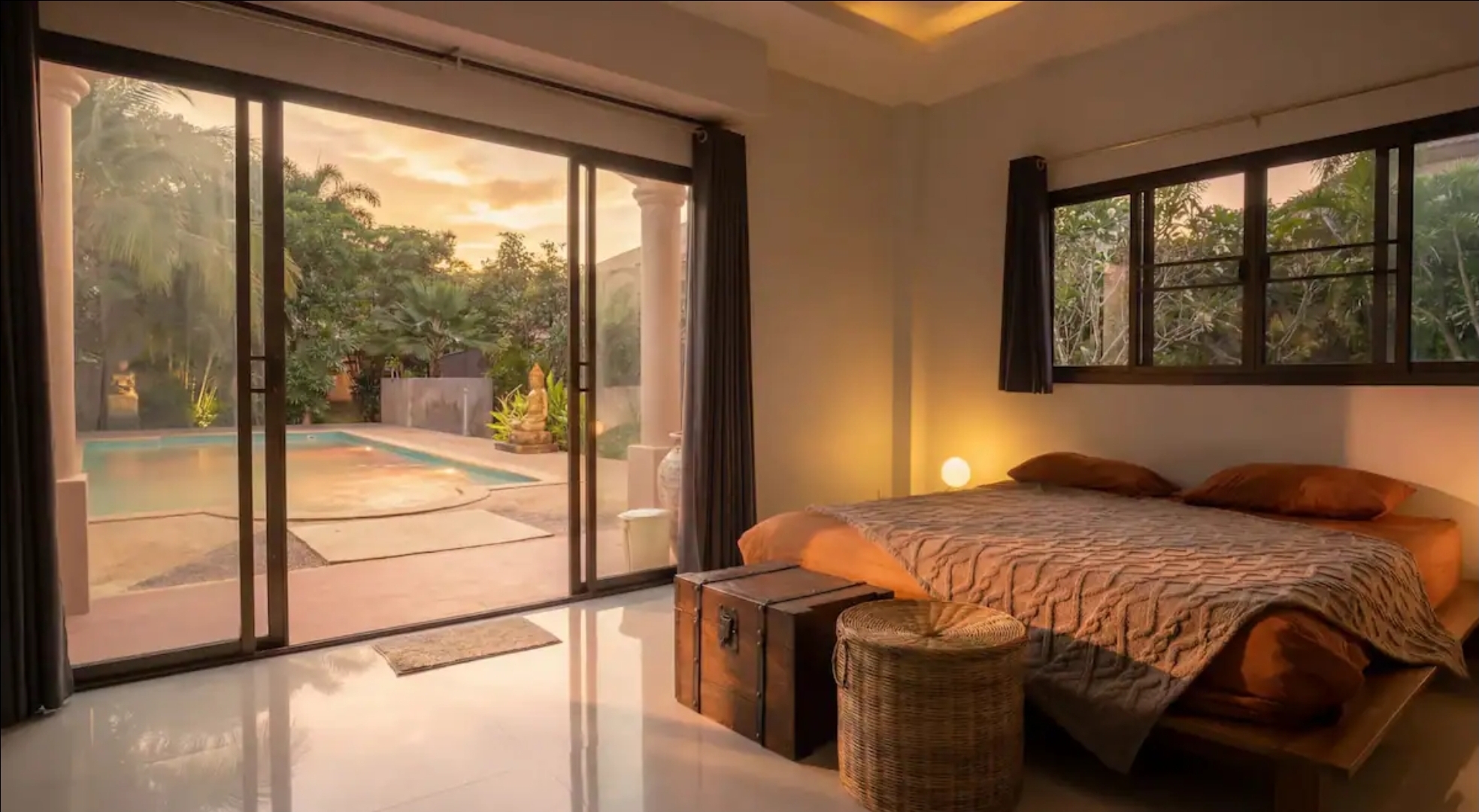 Pool-view bedroom at sunset in the 5-bedroom AYEDA pool villa